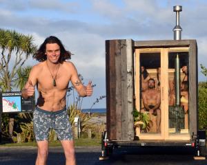 Oranga Saunas founder Josiah Lilburne tries out his portable sauna at Brighton Beach. PHOTO:...