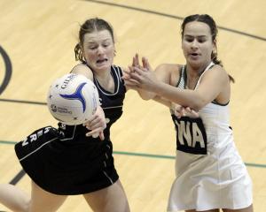 Southern Magpies centre Emma de Lautour (left) blocks a pass intended for Columba College wing...