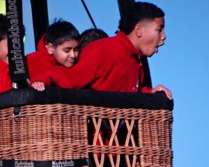 Manshil Mani (left), 10, and Haisini Manu, 10, are amazed at how high they are when a hot air...
