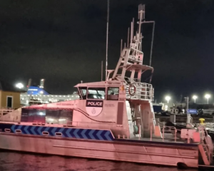 The Wellington police boat moored at Wellington Harbour after spending the day searching for a...