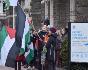Pro-Palestine demonstrators stand outside the Dunedin District Court in support of a fellow...