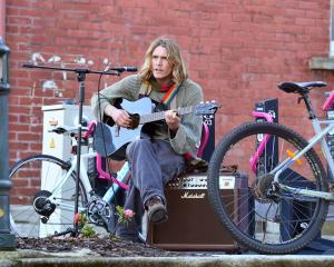 Dunedin musician Sam Charlesworth shares music in Albany St after plugging his amplifier into an...