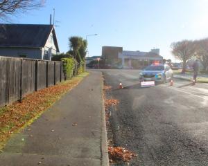 Police near the scene in Invercargill on Sunday morning. Photo: Nina Tapu