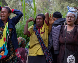 Women grieving at Yambali village in Papua New Guinea's Enga Province, where about 2000 people...