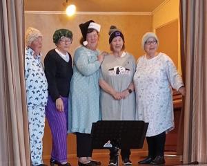 Singing the bedtime classic about the little one who said "roll over" are (from left) Jan Dugdale...