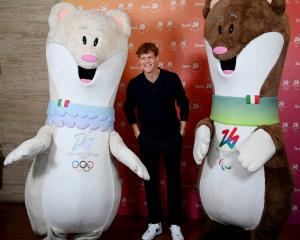 World No 1 tennis player Jannik Sinner, of Italy, poses with Tina (left) and Milo, the mascots...