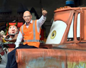 Dunedin Santa Parade Trust chairman John Marsh sits on the bonnet of the Tow Mater float...