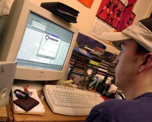 A New York University student downloads music from the Napster site in March, 2001. PHOTO: GETTY...