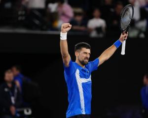 Novak Djokovic celebrates his win over Carlos Alcaraz at the Australian Open last night. Photo:...