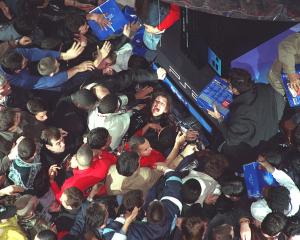 Shoppers push and shove during the launch of Playstation 2, at Paris’ Virgin Megastore, in...