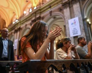 Catholic faithful attend a mass at the Metropolitan Cathedral in Buenos Aires to pray for Pope...