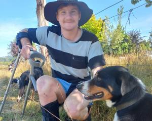 Injured cowboy Mitchell Gunn was back at the Lawrence rodeo arena on Friday to sell dogs Leo ...