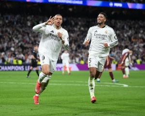 Kylian Mbappe celebrates his third goal alongside Jude Bellingham during Real Madrid's win over...