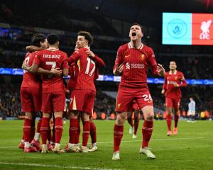 Andy Robertson celebrates in front of the Liverpool fans as Dominic Szoboszlai, Luis Duiz and...