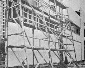 Rail-mounted scaffolding in use at the New Zealand and South Seas Exhibition construction site on...