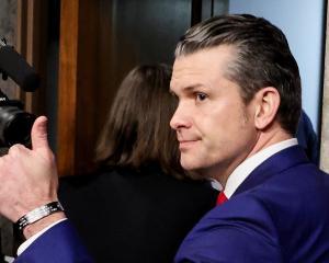Pete Hegseth gives a thumbs-up as he leaves a Senate Committee on Armed Services confirmation...