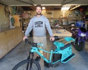 Alexandra man Scott Kvick poses with the first Long John bike in front of the shed the bike was...