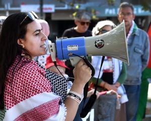 Organiser Rinad Tamimi speaks to the protest group who gathered in the Octagon on Saturday to...
