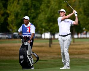 Daniel Hillier plays a shot at the New Zealand Open at Millbrook as caddy Steve Williams keeps a...
