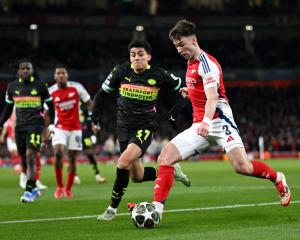 Kieran Tierney of Arsenal looks to cross the ball whilst under pressure from Richard Ledezma of...