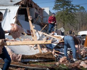 Clean-up begins in the Alabama town of Calera after a tornado ripped through houses. Photo: Getty...