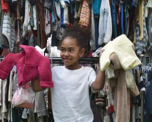 Hannah Cagilevu, 6, of Dunedin, picks out some new clothes during the Kids Preloved Winter Sale...