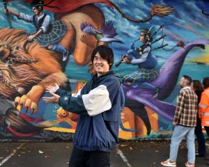 South Dunedin Street Trail artist Koryu Aoshima in front of the extension to his Cameron St mural...