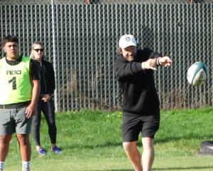 Rugby Bricks founder and coach Peter Breen demonstrates a passing drill during a skills session...