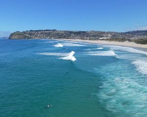 Surfers in action at Dunedin’s St Kilda Beach on a beautiful autumn day on Saturday. PHOTO:...