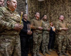 Ukrainian service members attend an Easter service near a front line in Dnipropetrovsk region....