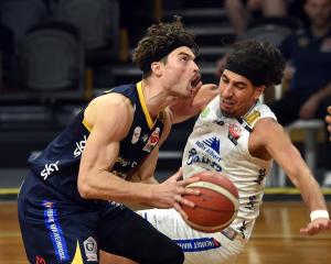 Otago Nuggets guard Matt Bardsley evades Wellington Saints guard Rangimarie Dougall-Mita during...