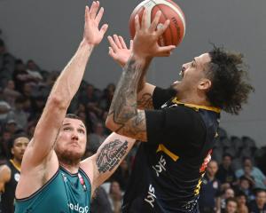 Otago Nuggets small forward Jose Perez gets a shot off despite the attention of Auckland forward...