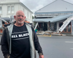 Martinborough building owner Bruce Sullivan in front of his damaged cafe. Photo: RNZ