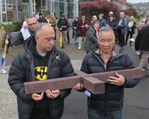 Pesamino Tili (left) and Frank Liman carry the cross from the Mosgiel Presbyterian Church&nbsp...