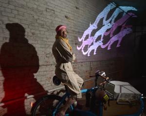 Wellington artist and designer Marcus McShane projects a pack of wolves on to a central Dunedin...