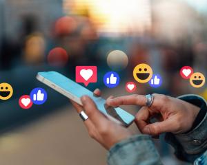 Checking social media with a smartphone. PHOTO: GETTY IMAGES