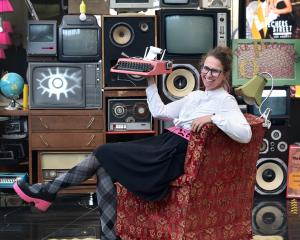 Artist Katja Starke, of Wellington — playing the role of a typist assistant — reclines in a red...