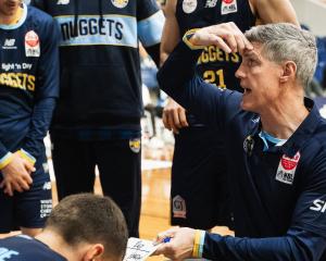 Otago Nuggets coach Mike Kelly gives some instructions to his players during an NBL game against...