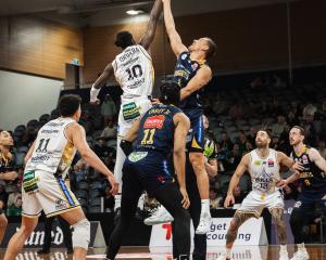 Otago Nuggets forward Jonathan Janssen (left) and Franklin Bulls forward David Okwera compete for...