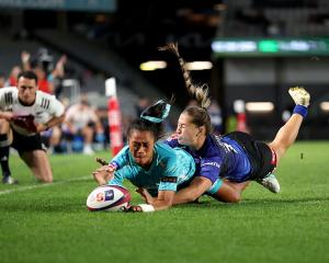 Matatū winger Winnie Palamo is tackled by Blues opposite Jaymie Kolose while scoring a try during...