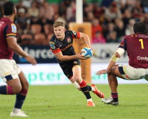 Damian McKenzie of the Chiefs makes a break during tonight's Super Rugby Pacific match against...