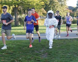 Ryan Yoon broke his own world record for running a half-marathon in a beekeeping suit. He...