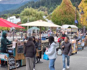 Stallholder Nicholas Cantaro serves customers on Queenstown’s waterfront on Thursday. PHOTO: GUY...