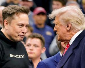 Elon Musk (L) greets US President Donald Trump at a wrestling event in Philadelphia in March....