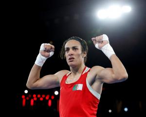 Algeria's Imane Khelif celebrates after beating China's Liu Yang in the women's 66kg boxing final...
