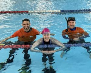 Kathryn Nevatt taking a breather last weekend with competition safety divers Adrian Bosi, left,...