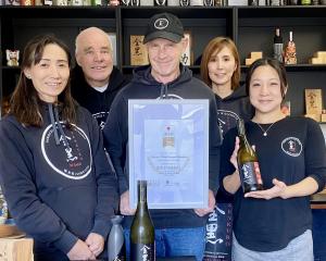 Celebrating their latest success, from left, are operations manager Yasuko Joll, director Richard...