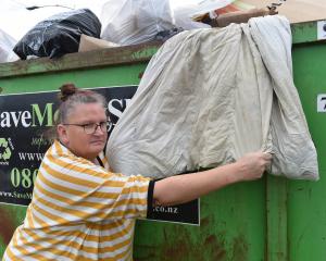 Dunedin Bedding Bank founder Janine Walker holds a mouldy donated duvet wet with possible urine...