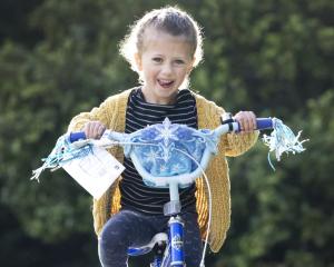 Nora Gorton tries out a bike she got from the Southern Youth Development bike grab yesterday....