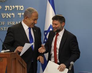 Israel's finance minister, Bezalel Smotrich, right, greets Israeli Prime Minister Benjamin...